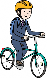 乗車用ヘルメットを着用し、自転車を運転する人