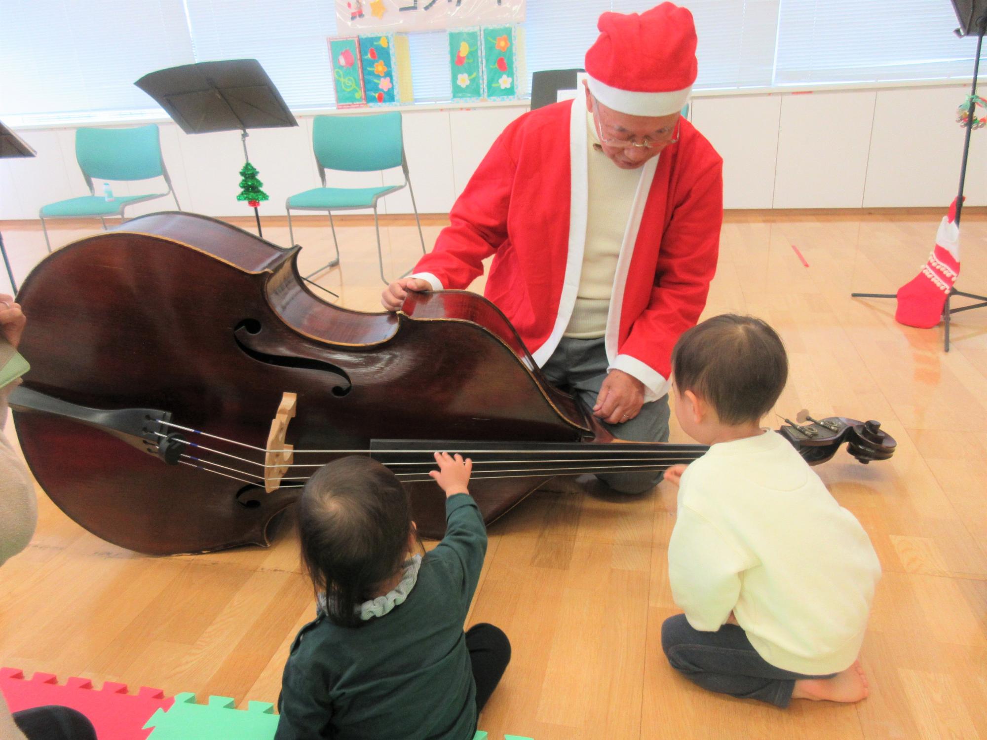 興味津々で楽器を触れせてもらっているこどもの様子