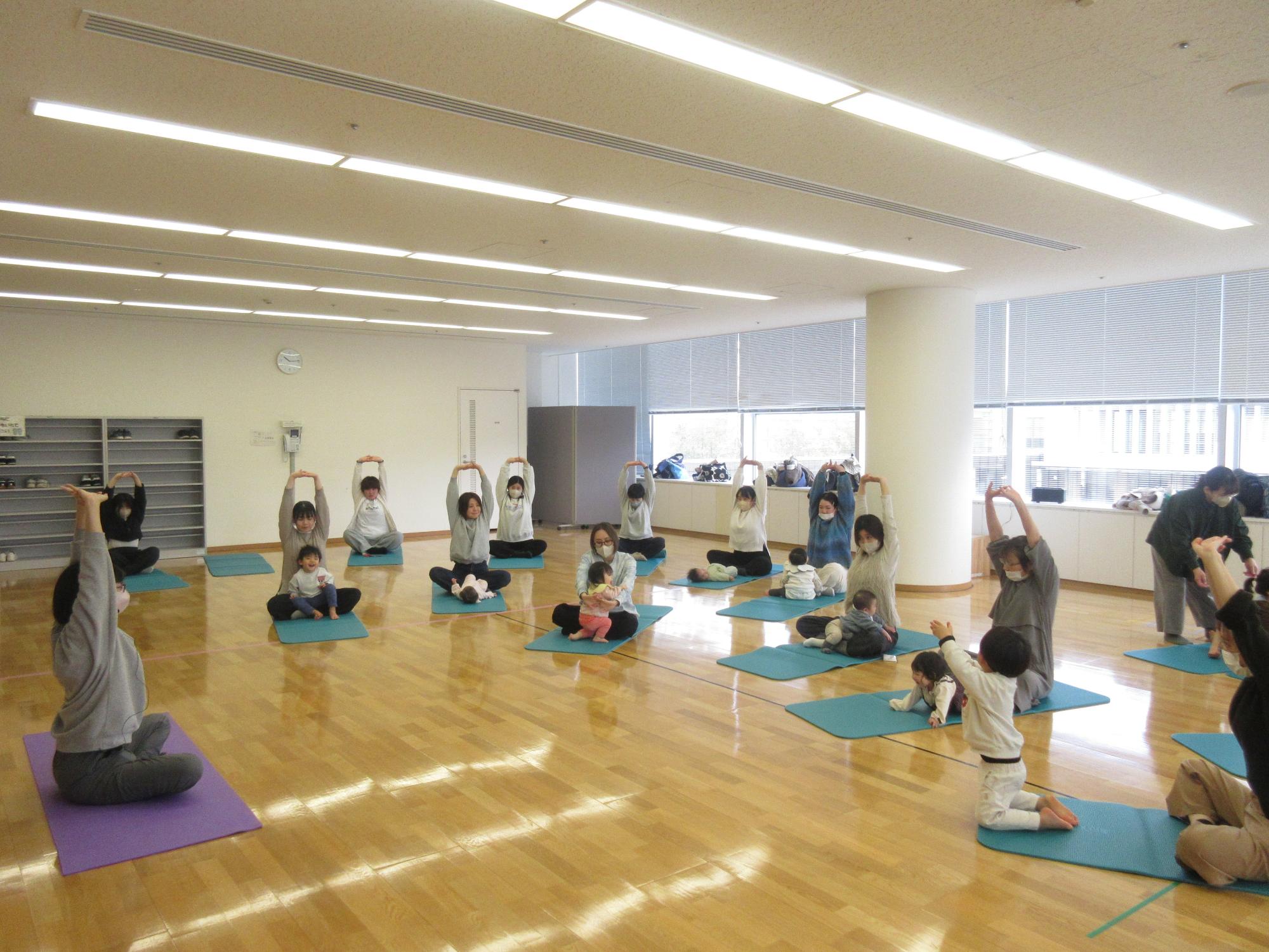 あいあいぼっくすでストレッチをする母親